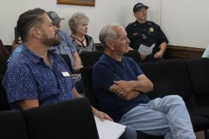 Mayor Pro-Tem Chip Joslin, left, sits in the audience section of Glen Rose City Council Chambers during public comment regarding a lawsuit he filed against the city and City Administrator Michael Leamons. (Ann Powers Photo)